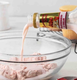 Pennsylvania Dutch Strawberries & Cream being poured into a strawberry frosting
